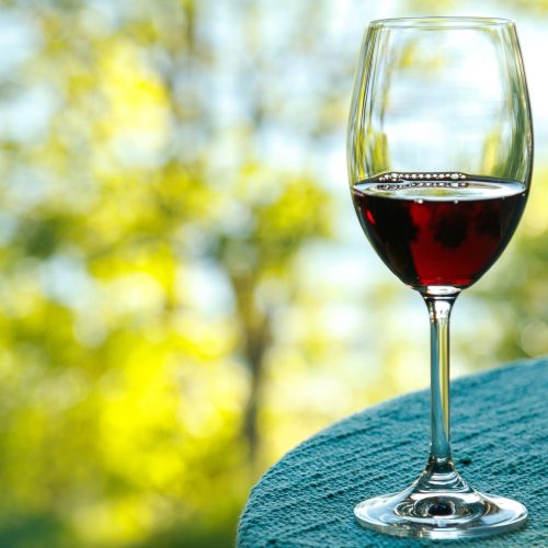 Glass of wine on the table with a bokeh on the background